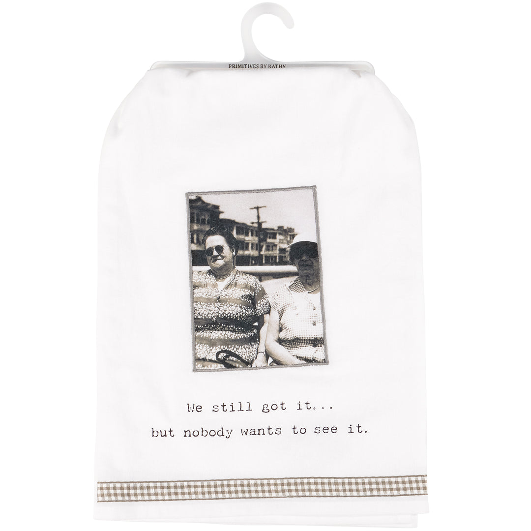 Cotton kitchen towel with humorous quote, black-and-white photo, brown checked trim. Available in multiple sizes.