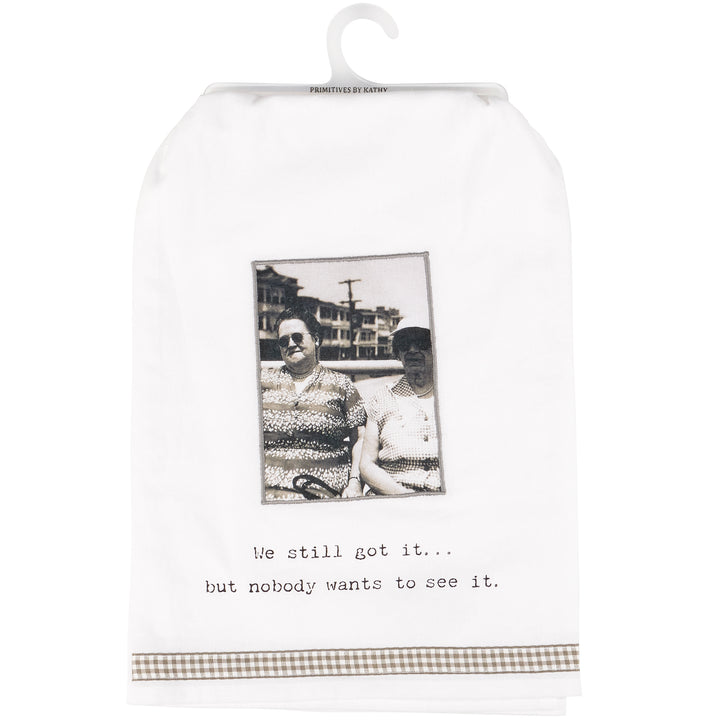 Cotton kitchen towel with humorous quote, black-and-white photo, brown checked trim. Available in multiple sizes.
