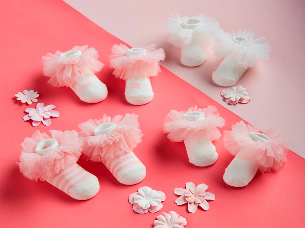 Five pairs of Tutu Baby Socks with pink and white frilly tulle cuffs. Available in sizes 0-12 months.