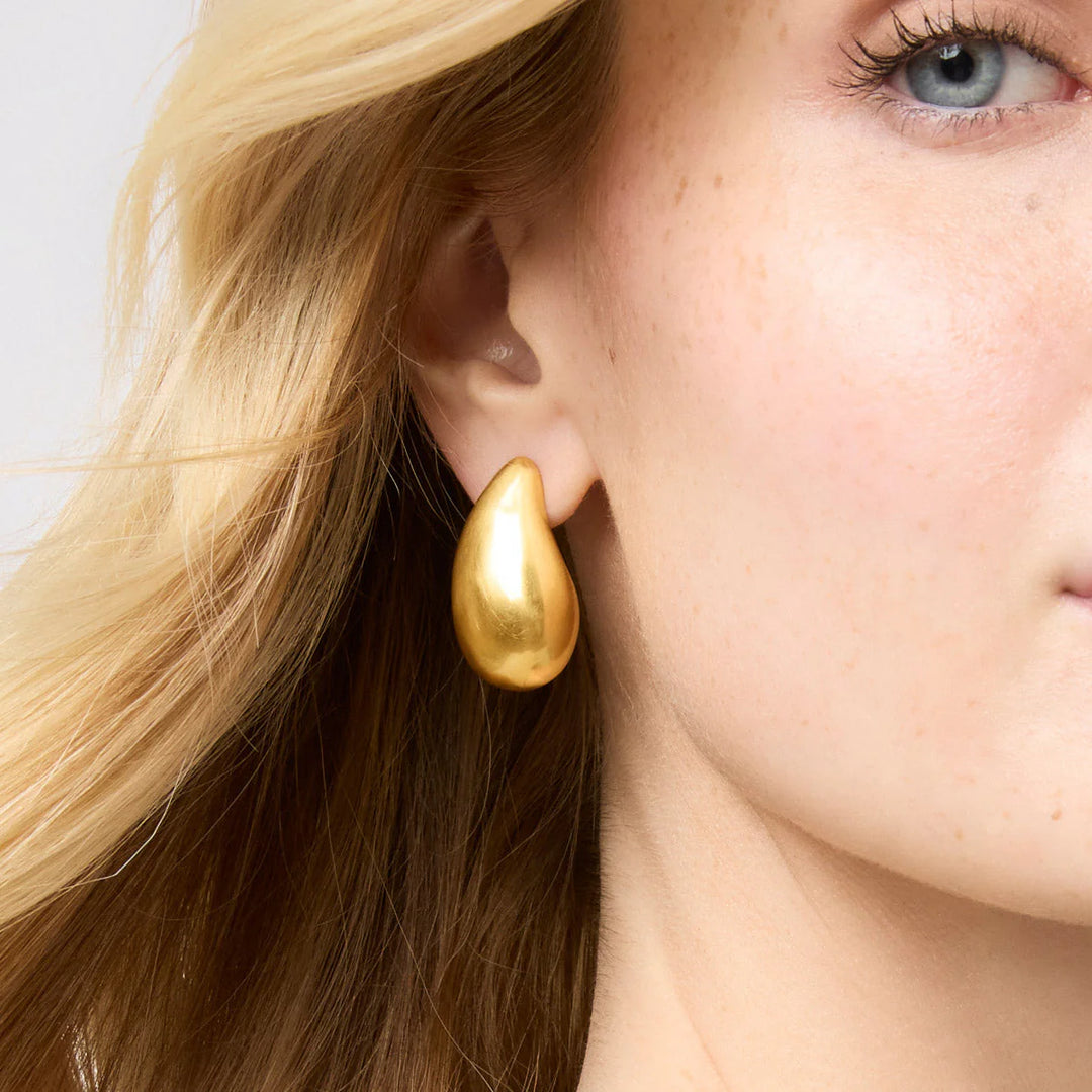 Close-up of Julie Vos Wave Earrings: large, smooth 24K gold-plated design. Available in small and large sizes.