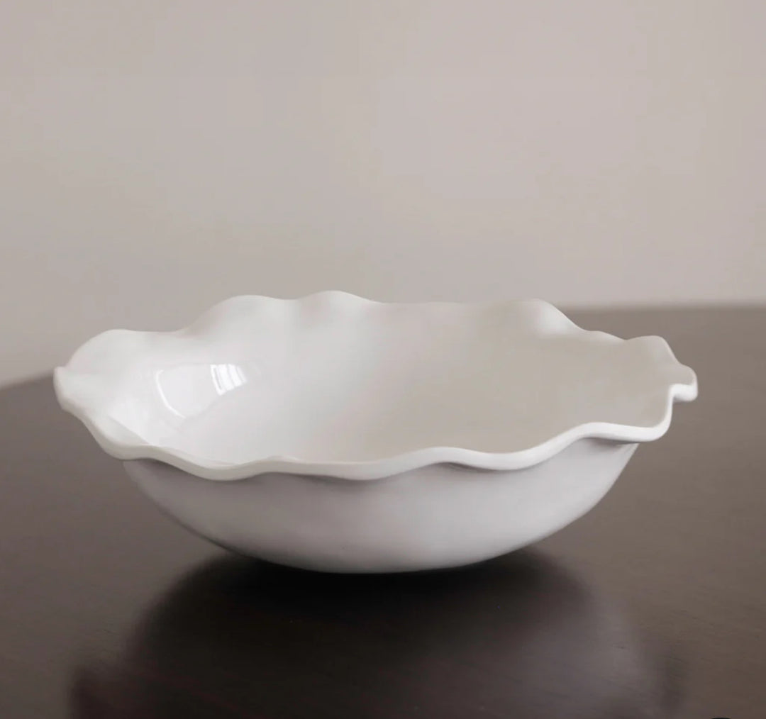 White, scalloped-edged ceramic bowl with a smooth, glossy finish. Available sizes: Medium (10"), Large (12").