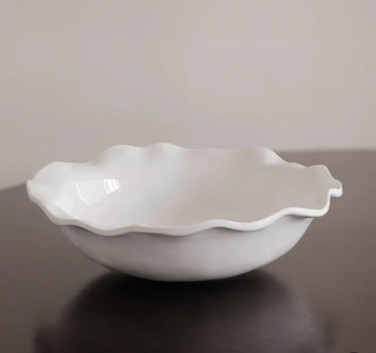 White, scalloped-edged ceramic bowl with a smooth, glossy finish. Available sizes: Medium (10"), Large (12").