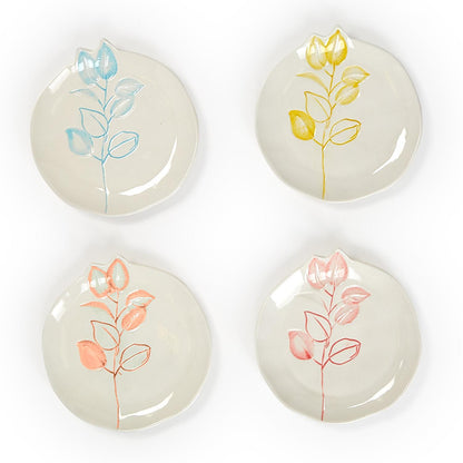 Set of four round plates with unique blue, yellow, orange, or pink floral designs. Each plate is 6" diameter.