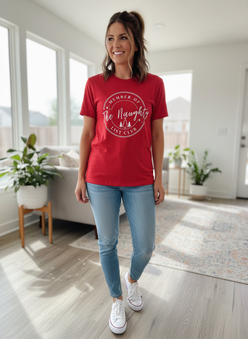 Red short-sleeve Christmas T-Shirt with “Member of the Naughty List Club” graphic. Available in all sizes.