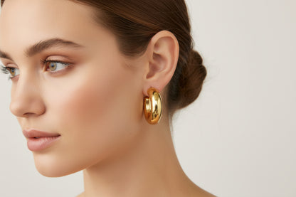 Large, shiny gold hoop earrings. Available in small, medium, and large sizes.