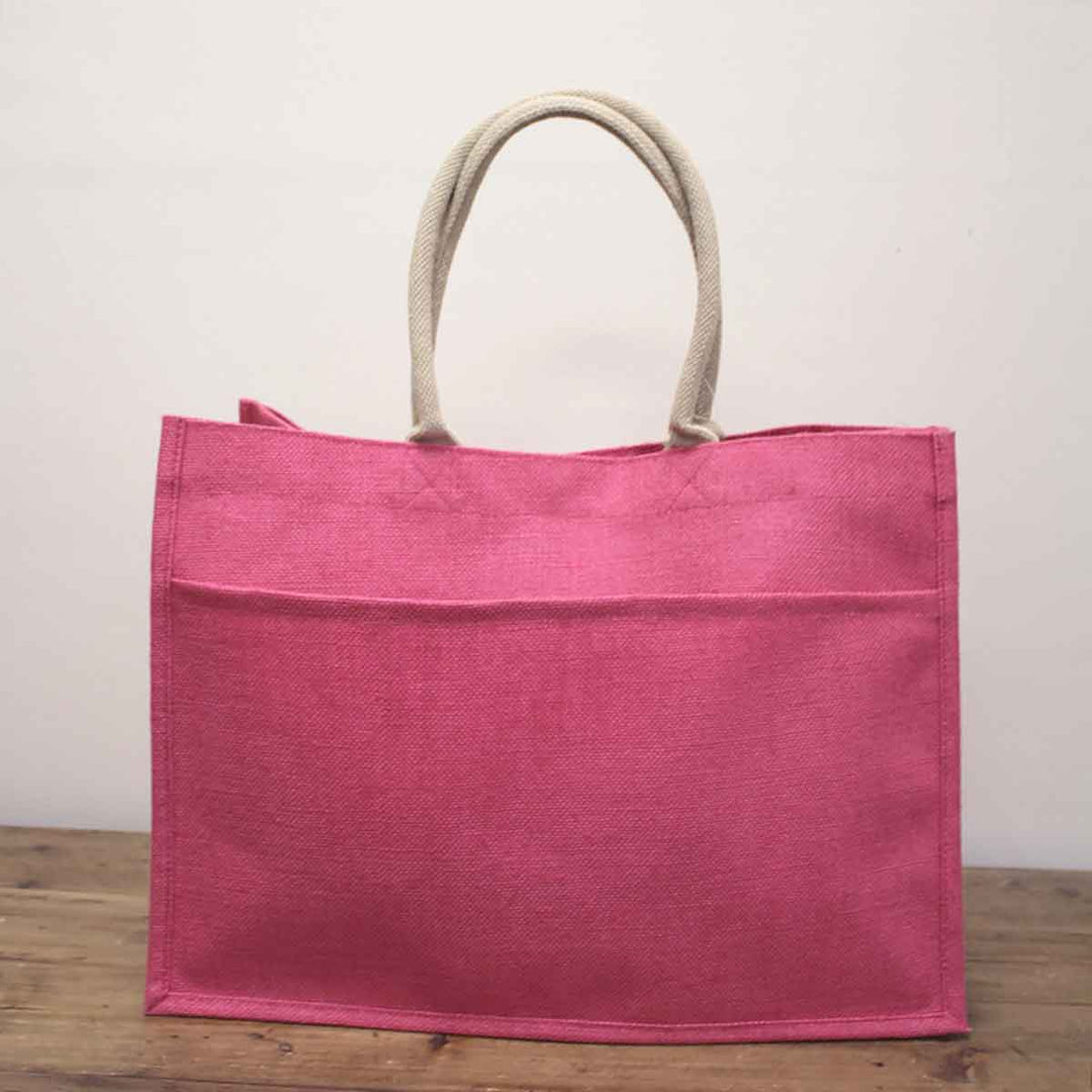 Pink Jute Pocket Tote with beige rope handles. Available in small, medium, and large sizes.