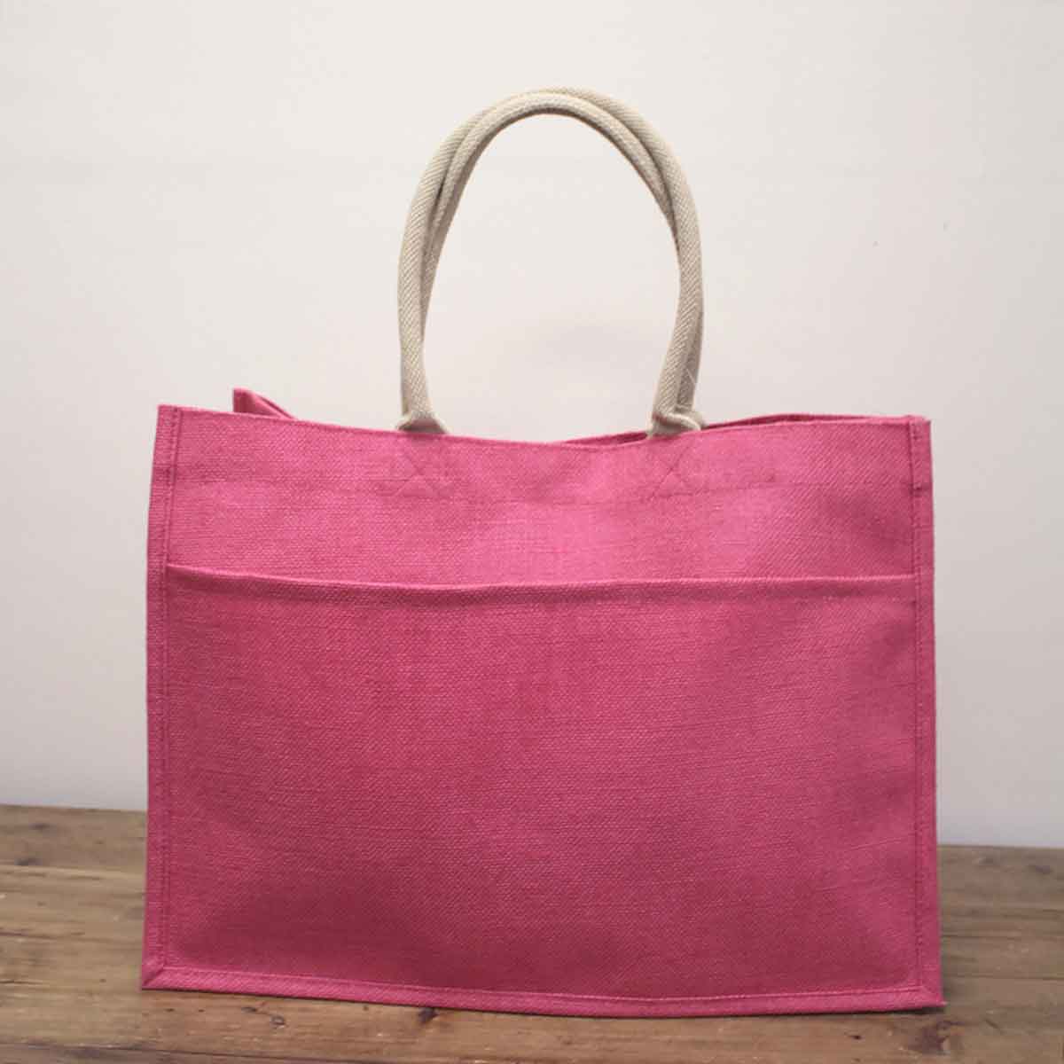 Pink Jute Pocket Tote with beige rope handles. Available in small, medium, and large sizes.