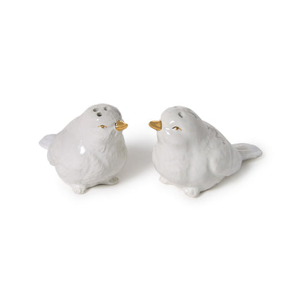 White ceramic bird salt and pepper shakers with gold beaks in a nest carrier; available in standard 2.5" size.