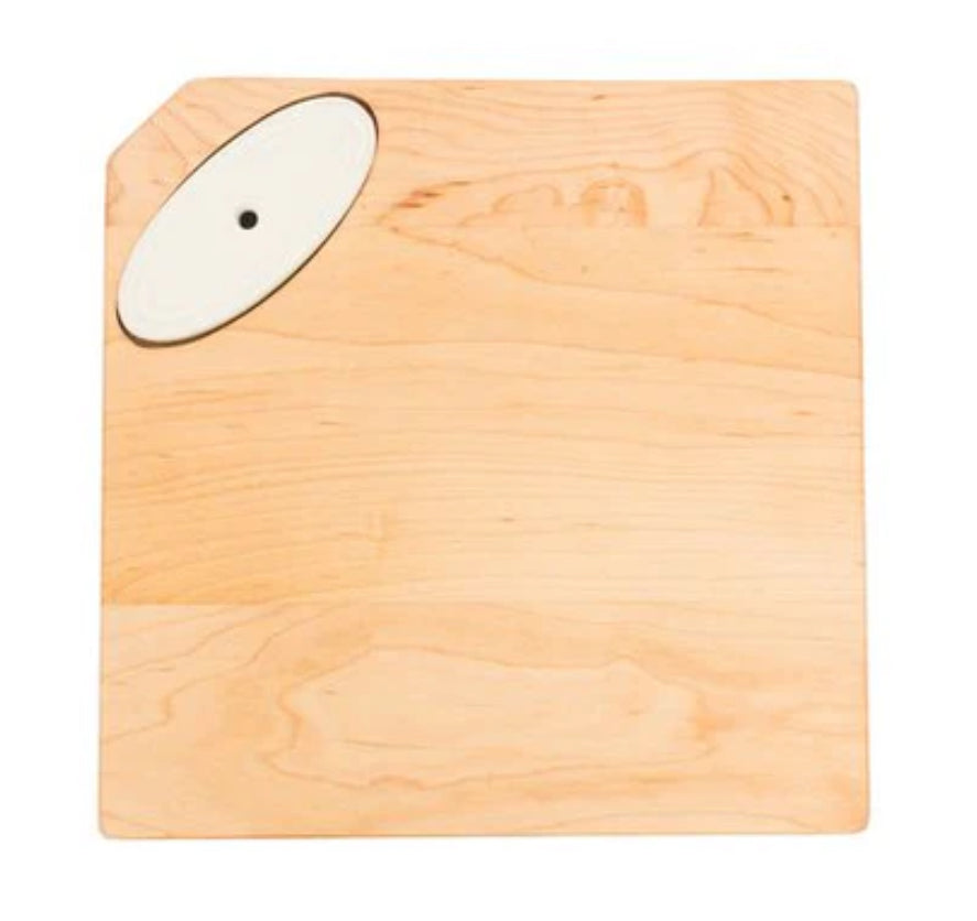 **The Maple Cheese Board by J.K. Adams**

- Square wooden cutting board
- Light natural finish
- Oval-shaped white ceramic accent in the top left corner
- Crafted from maple wood with a slightly rounded corner opposite the ceramic accent

**Available Sizes:**
- 10" x 10"
