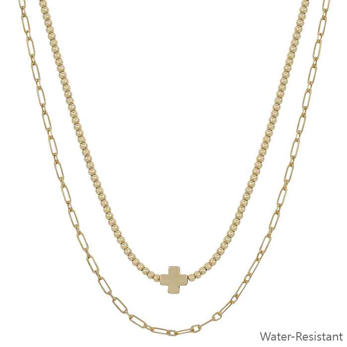 Water resistant layered necklace with gold cross pendant, small beads, chain link. Available in 16", 18", and 20" lengths.