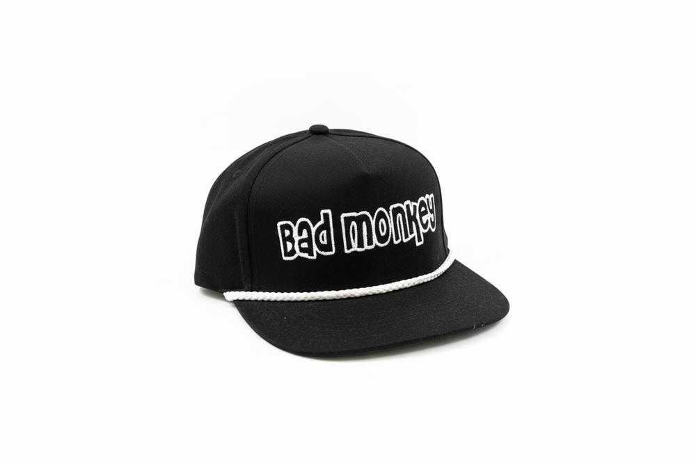 Black adjustable "Bad Monkey" hat with white rope above brim; bold white front lettering. Available in one size fits most.