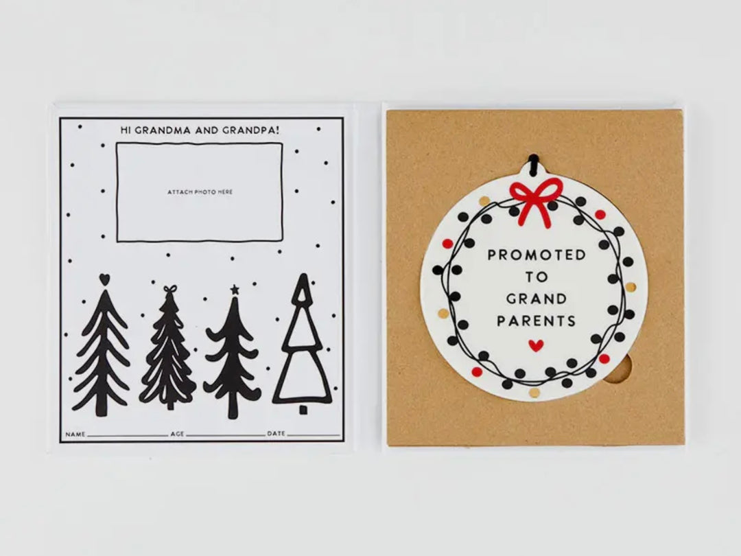 Round white Promoted To Grandparents ornament with red ribbon and black dot wreath.