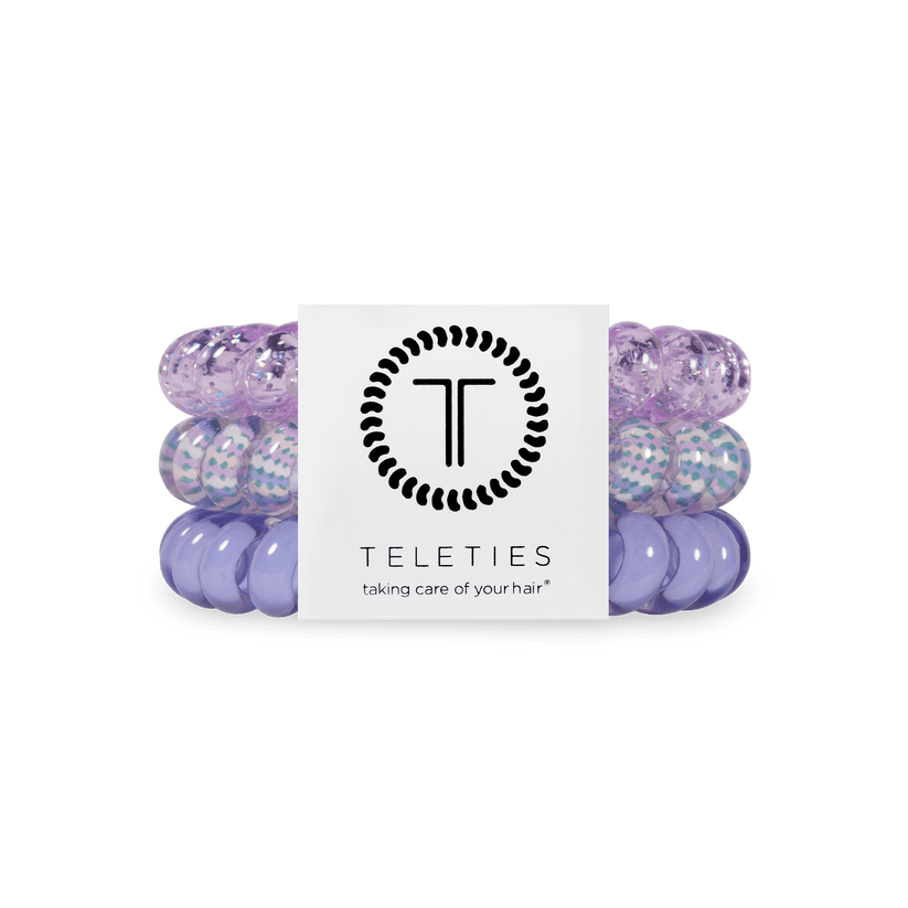 Set of three purple coiled TELETIES hair ties with branded card; available in small and large sizes.