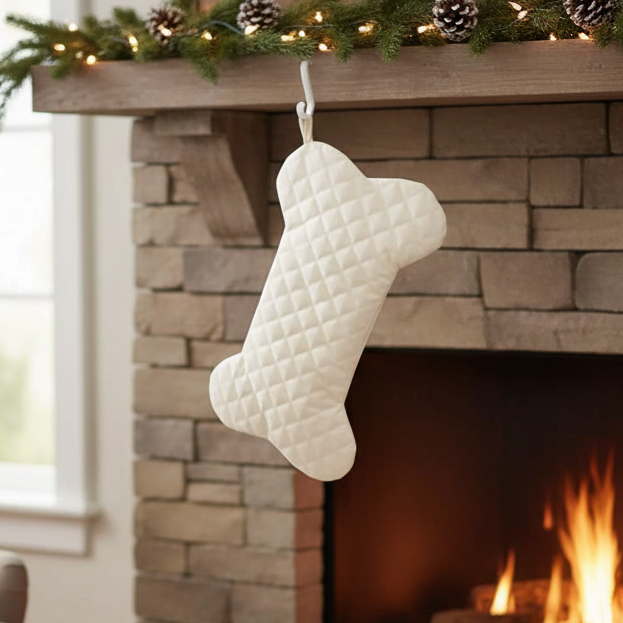 Cream-colored, quilted dog bone stocking with a diamond pattern.