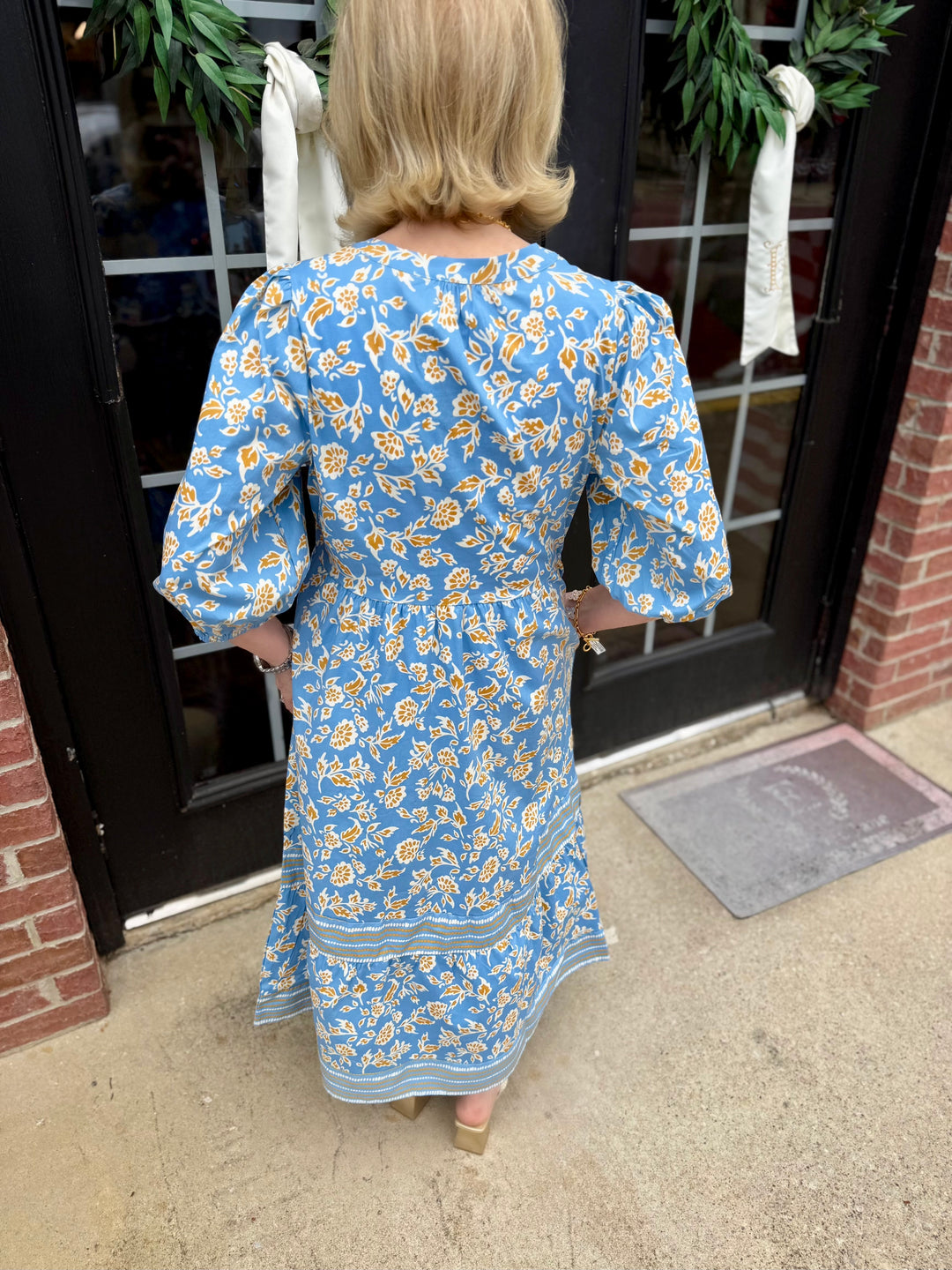 Riley Ivy Script Gold Dress: blue with yellow and white florals, 3/4 sleeves, tiered midi skirt. Available in sizes XS-XL.