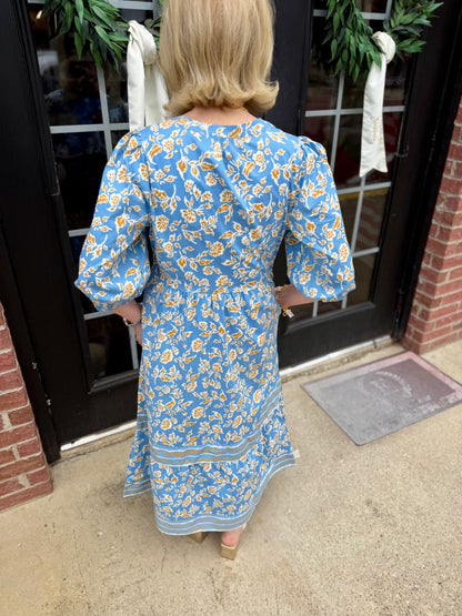 Riley Ivy Script Gold Dress: blue with yellow and white florals, 3/4 sleeves, tiered midi skirt. Available in sizes XS-XL.