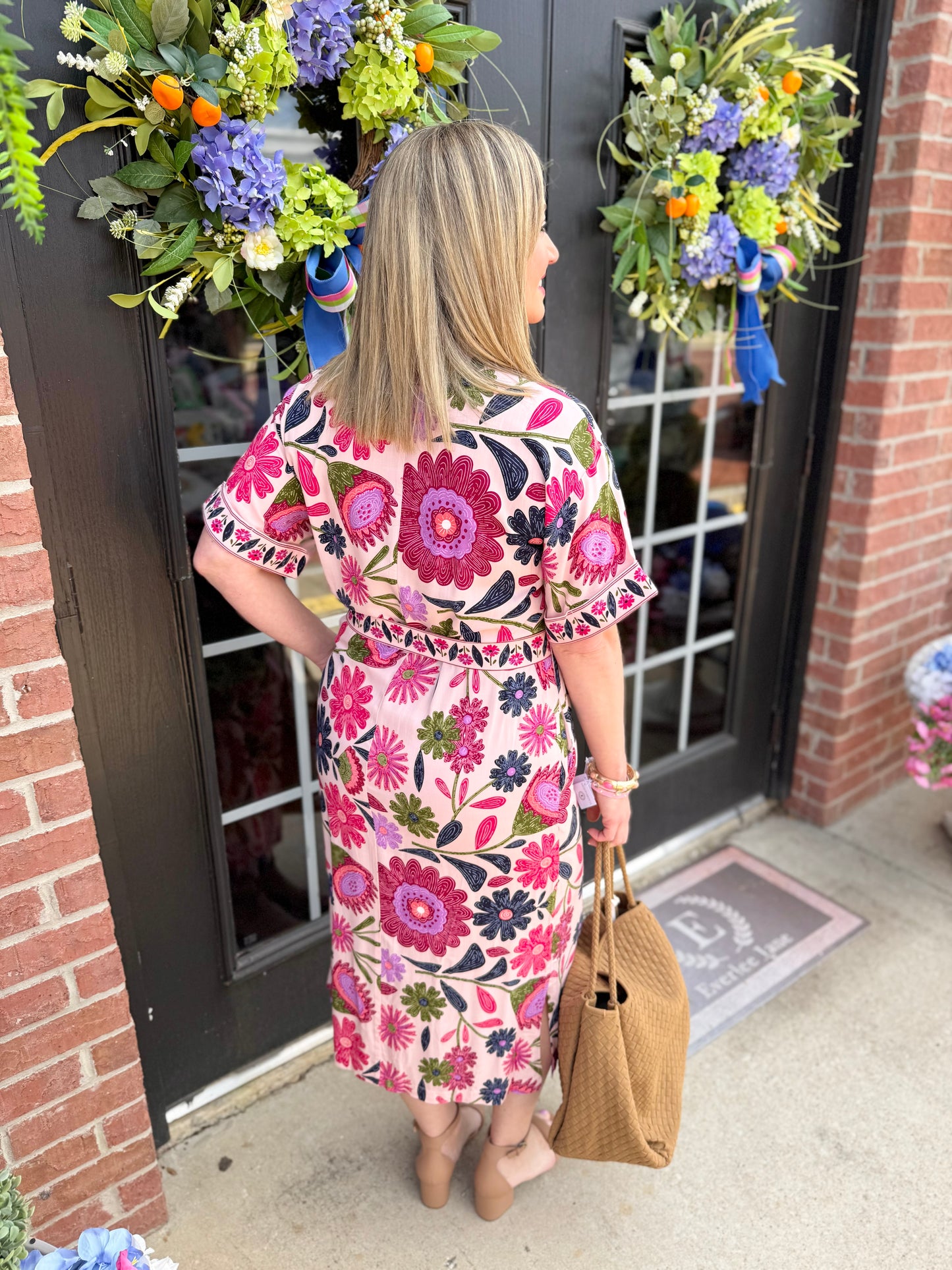 Pink button-up belted floral midi dress. Available in sizes XS–XL.