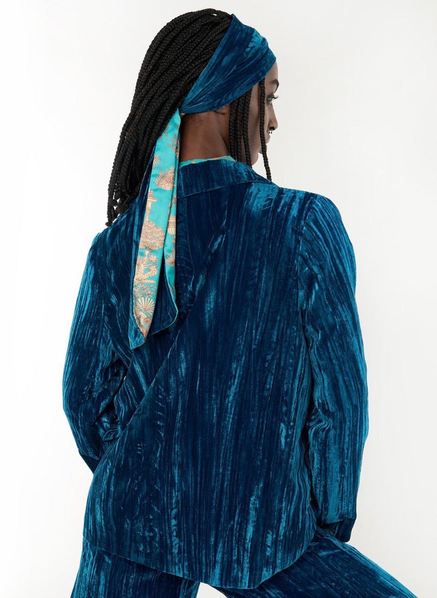 Kim Crushed Blue Velvet Jacket in blue crushed velvet, available in sizes XS–XL.