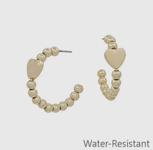 1” beaded hoop earring with gold heart accent, “Water-Resistant” label, available in 1-inch size only.