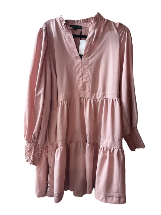 Loose-fitting salmon tiered dress with v-neck, ruffle neck, long sleeves, smocked cuffs; available in sizes XS-XL.