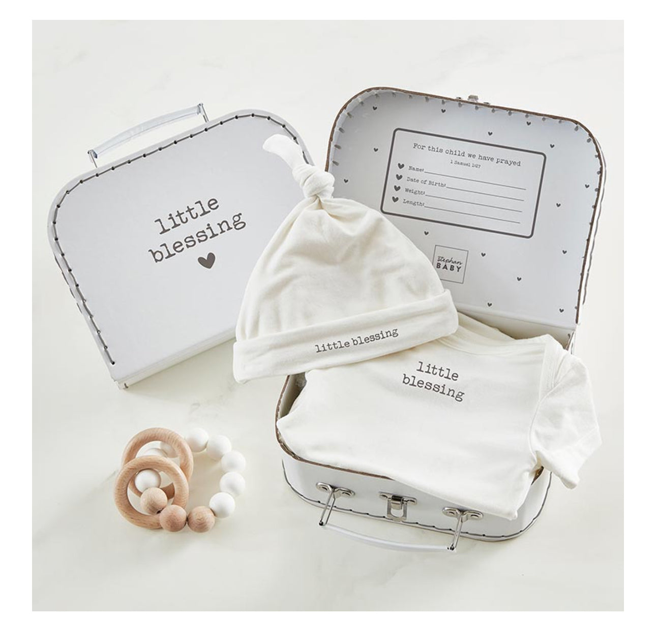 Little Blessing Gift Keepsake Box. Includes: white knotted hat, white onesie with "little blessing" print, baby teether (white and wooden beads), and compartments for baby details. Sizes available: Newborn.