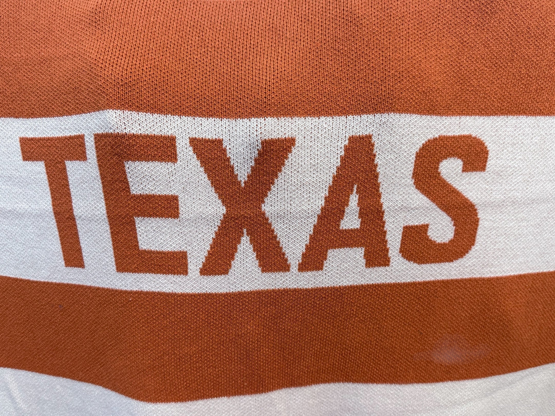 Knit Throw - Multi Stripe Texas featuring horizontal burnt orange and white stripes with the word “TEXAS” in large orange letters.