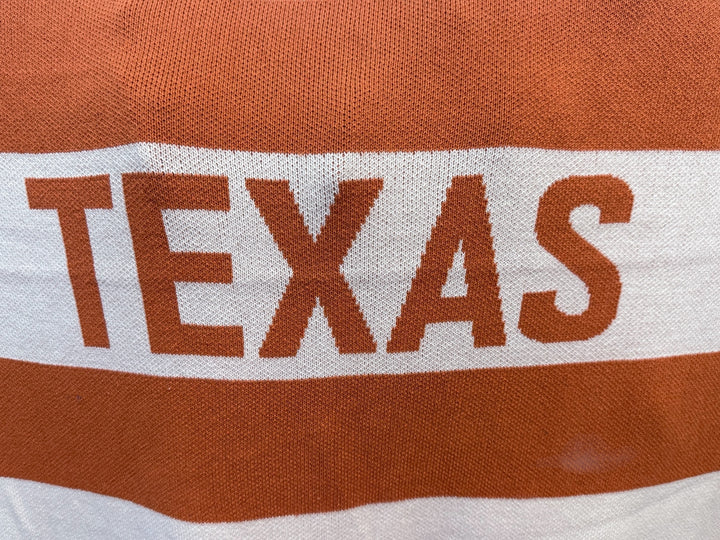 Knit Throw - Multi Stripe Texas featuring horizontal burnt orange and white stripes with the word “TEXAS” in large orange letters.