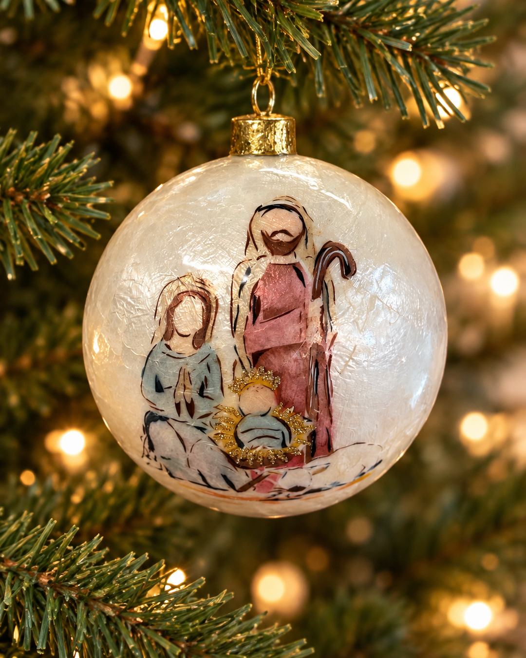 4″ Handpainted Holy Family Capiz Ornament, a 4″ round handpainted capiz shell Christmas ornament depicting the Nativity scene.