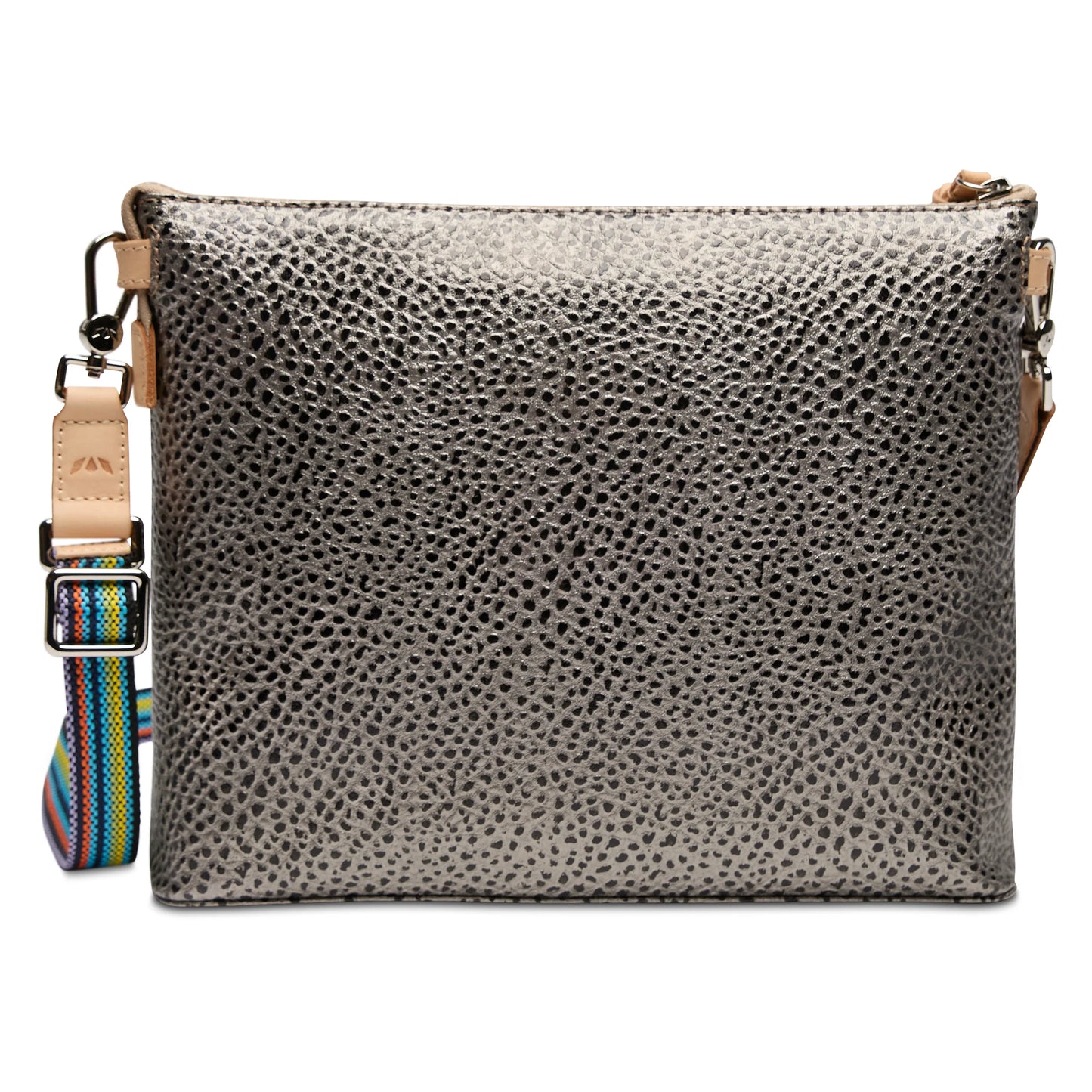 The Downtown Crossbody, Tommy has a metallic silver textured finish with beige leather trim, and a detachable, adjustable multicolored striped strap. Available in small and medium sizes.