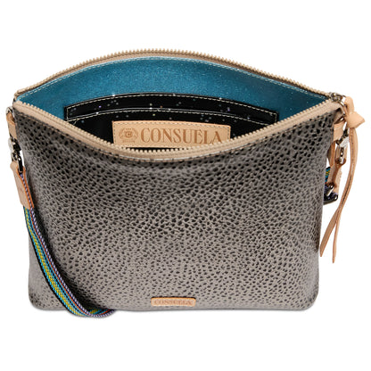 Textured gray leather crossbody bag with zip closure, teal lining, black pocket, vibrant adjustable strap, and interior Consuela label. Sizes available: not specified.