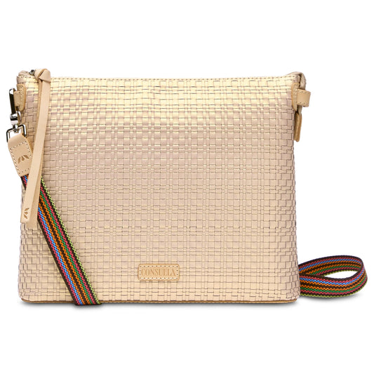 Beige woven crossbody bag with textured exterior, colorful striped adjustable strap, and Consuela logo patch. Available in one size: 10” L x 3½” W x 9” H; drop: 16¼”–28”.