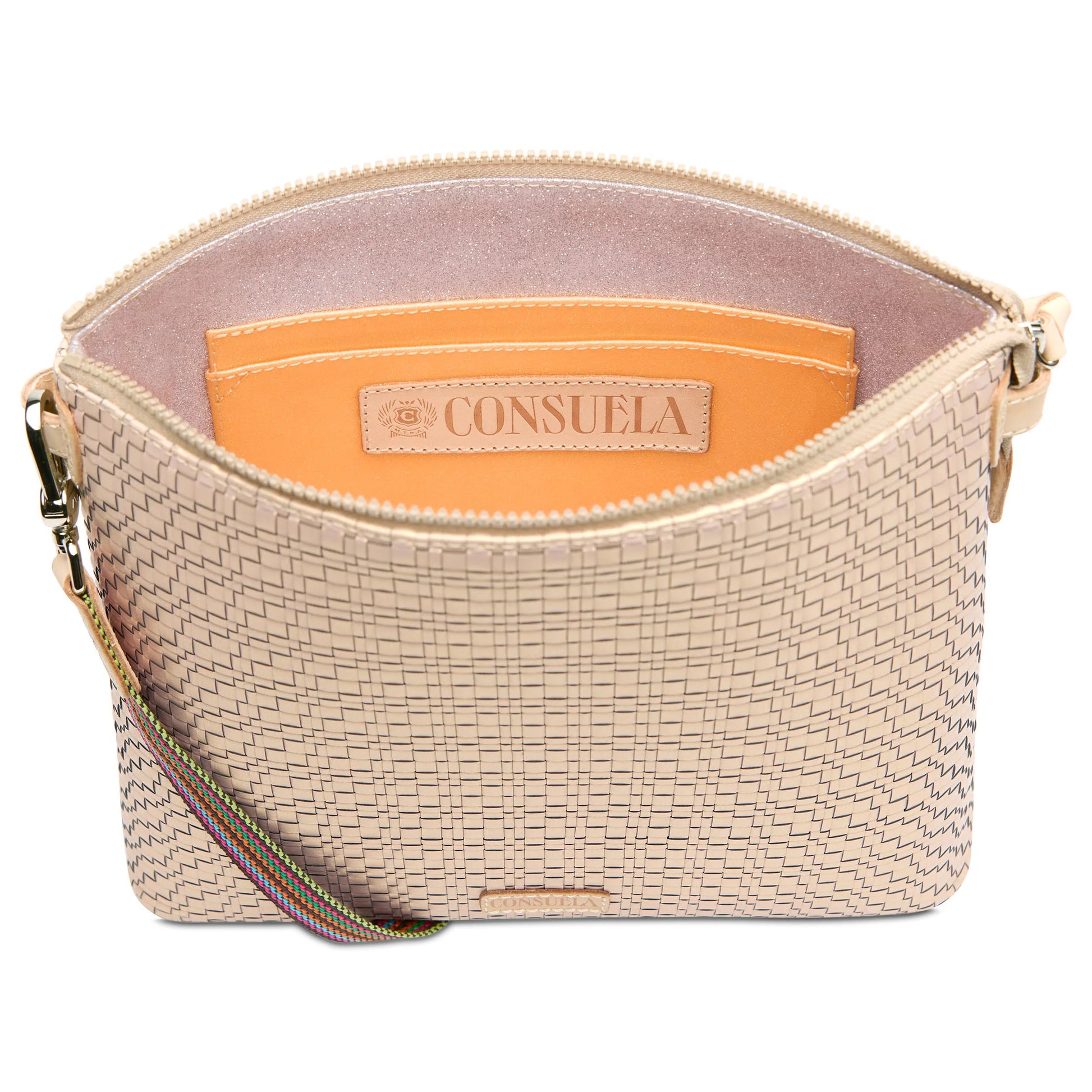 Beige textured crossbody with zippered top, brown leather interior pocket labeled "Consuela," and detachable striped adjustable strap. Sizes available: 9” L x 6” H x 2½” D; strap length adjustable from 37" to 58".