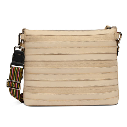 Beige Diego leather crossbody bag with horizontal stitched lines, wide adjustable striped strap, metal hardware, and zippered top closure. Available in multiple sizes.
