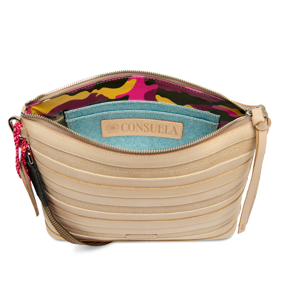 The Downtown Crossbody, Amina, is shown open with beige Diego leather, horizontal stitching, a colorful camouflage interior, blue “Consuela” pocket, and a detachable multicolored adjustable strap. Available in multiple sizes.
