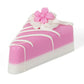Pink and white cake slice soap with white icing drizzle, frosting, and pink flowers. Available in 2 oz, 4 oz, and 6 oz sizes.