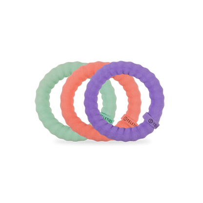 Three Teleties nylon hair ties in pastel green, coral, and purple. Available in small, medium, and large sizes.