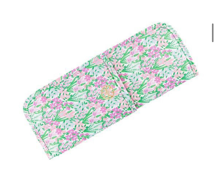 Rectangular wallet with pink and green floral pattern, gold emblem on flap; fits curling irons. Available in multiple sizes.