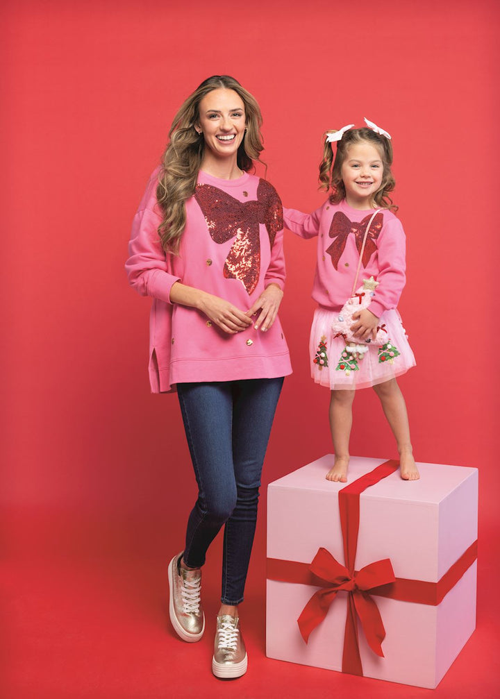 Pink French terry sweatshirt with a large red sequin bow, available in adult and child sizes.