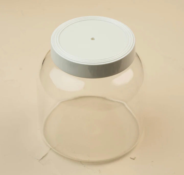 Clear glass jar with a white screw-on lid featuring a small central hole; available in multiple sizes.