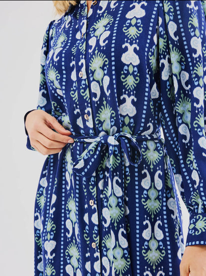 Blue Ava Ikat Stripe Dress with white and green patterns, puff long sleeves, front buttons. Available in sizes XS-XL.