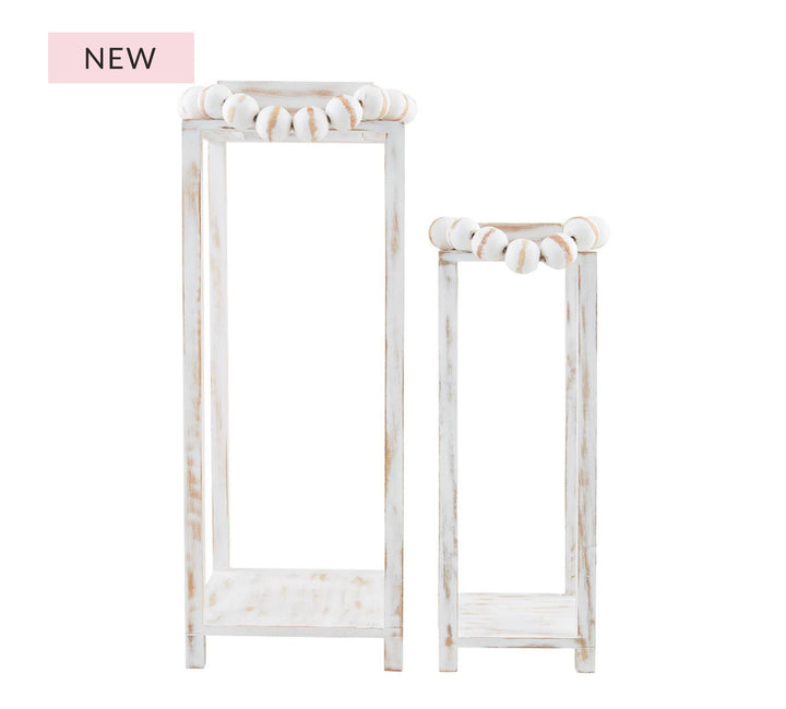 Set of two whitewashed wooden lanterns with bead top handles; includes one tall and one short lantern.