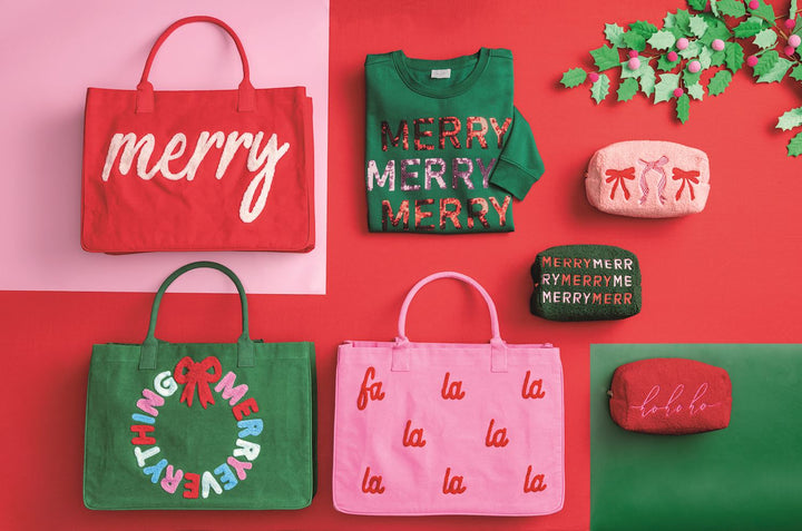 Holiday Boucle Tote, a red canvas bag featuring “merry” embroidered in white bouclé yarn.
