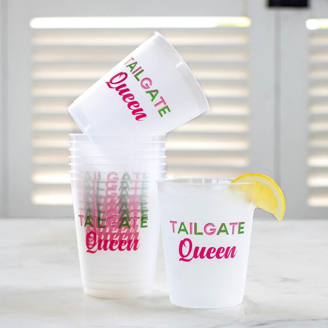 White "TAILGATE Queen" party cups with green and pink text, available in 16 oz size. Ideal for football gatherings.