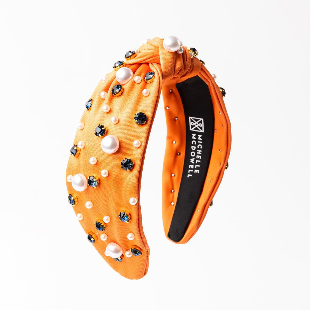 Navy &amp; orange headband with pearl and dark gemstone top knot, black lining, "Michelle McDowell" branding. Sizes: One size.