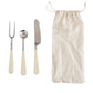Stainless steel fork, spoon, knife with white resin handles; comes with beige drawstring pouch. Sizes: small, medium, large.