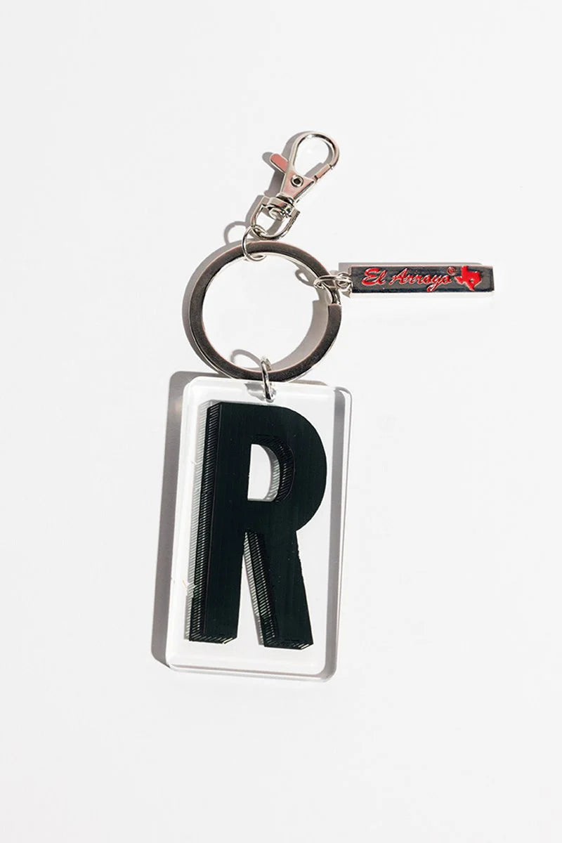 Keychain with large black "R" in clear rectangle, metal key ring, red "El Arroyo" tag. Size options: small, medium.
