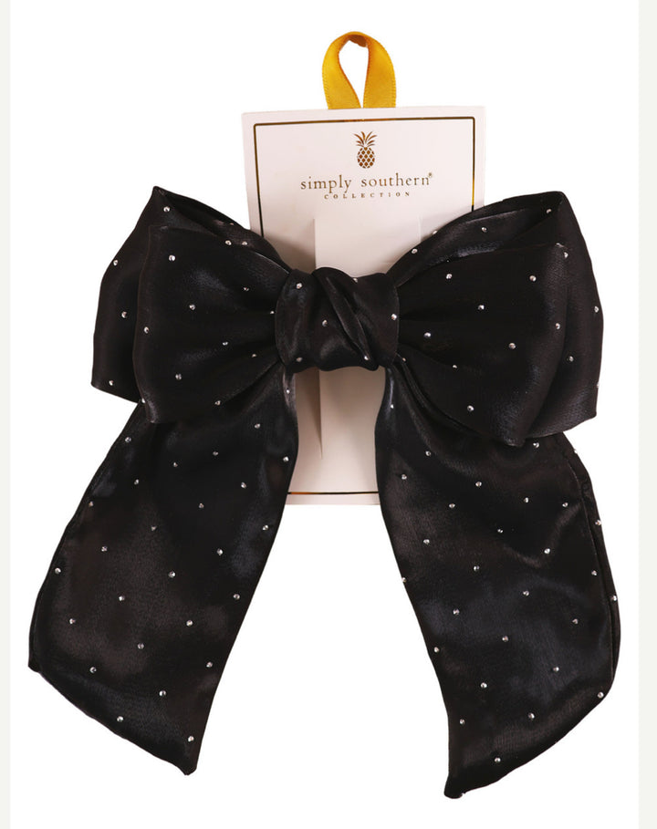 Large black satin bow with white polka dots, yellow ribbon loop, on "Simply Southern Collection" card. Sizes: S, M, L.