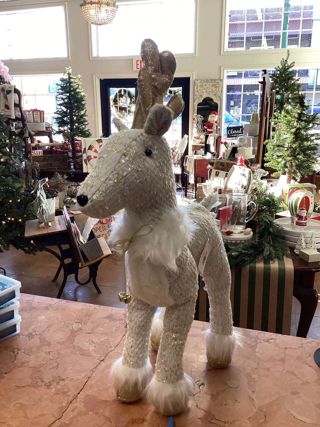 White and gold standing deer figurine with faux fur trim.