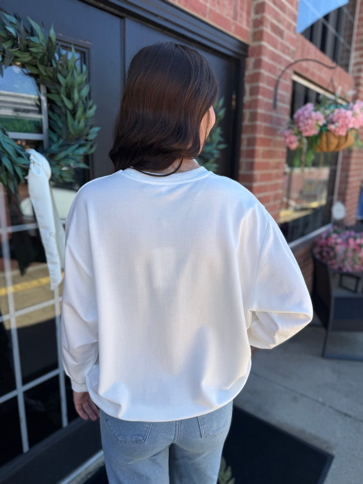 White Sarah Merry Boucle long-sleeve crewneck sweatshirt.