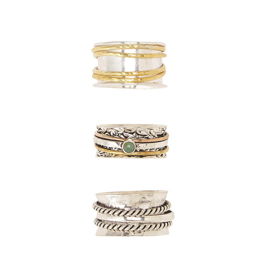 Three silver rotating rings: gold accents, textured details, green stone. Unique designs. Available in sizes 6-10.